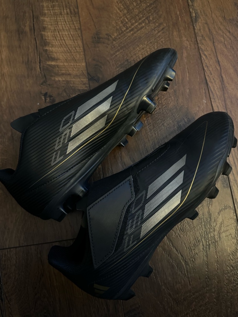 Kids Black Soccer Cleats with Metallic Accents. Big Kids size 5